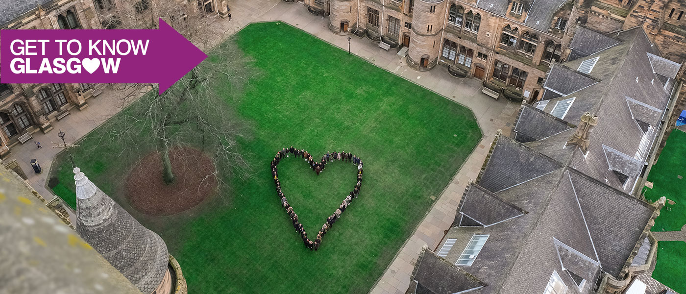 Students standing in the University quad, making the shape of a heart