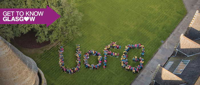 Students standing in the University's Quad spelling out U of G